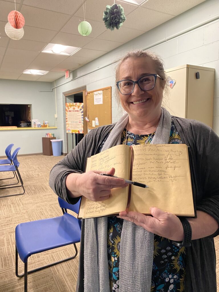 New members sign the book