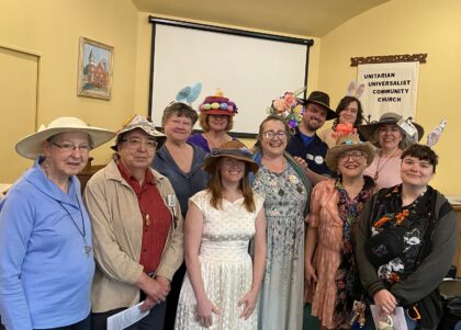 members wear elaborate Easter hats.
