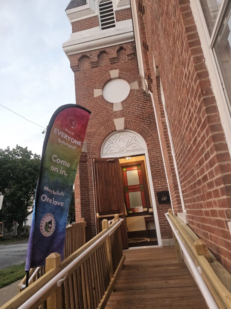 Front door of UUCCHC with a welcoming rainbow flag